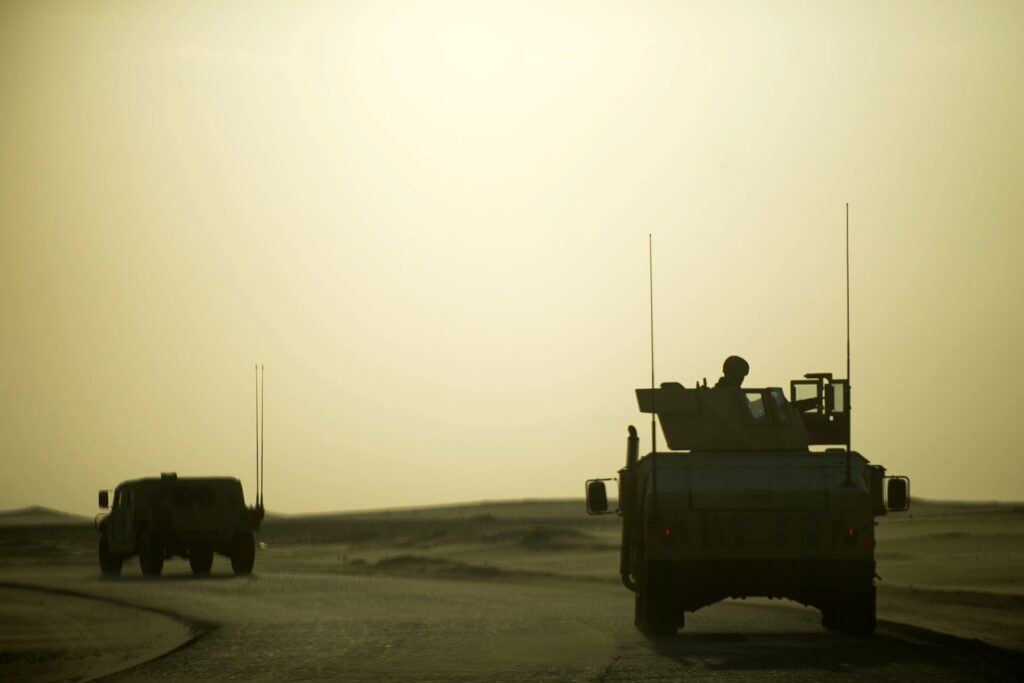 Military HMMWV Humvees driving in a convoy