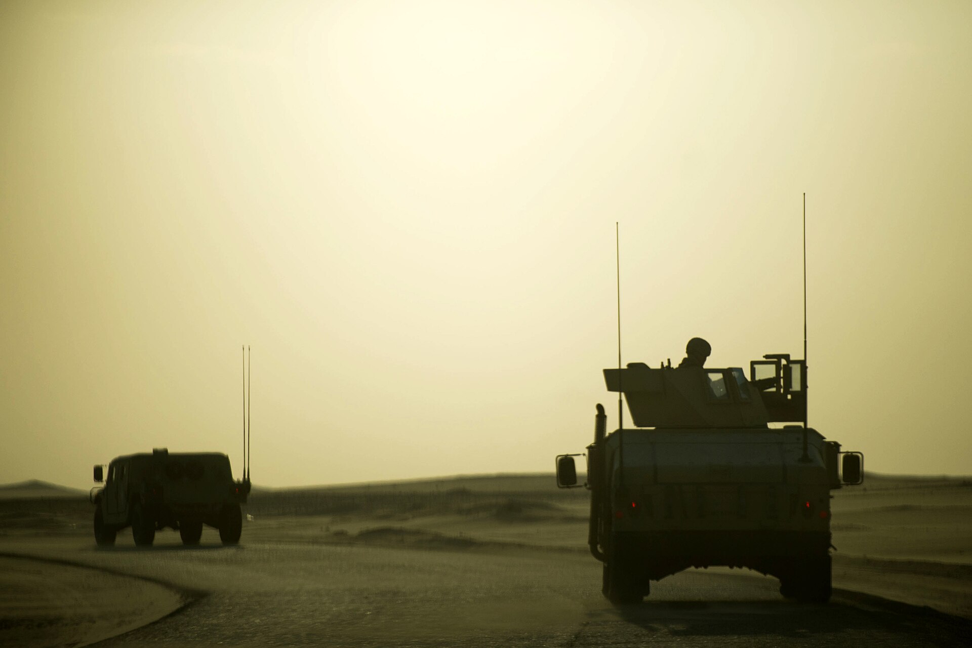 Military HMMWV Humvees driving in a convoy